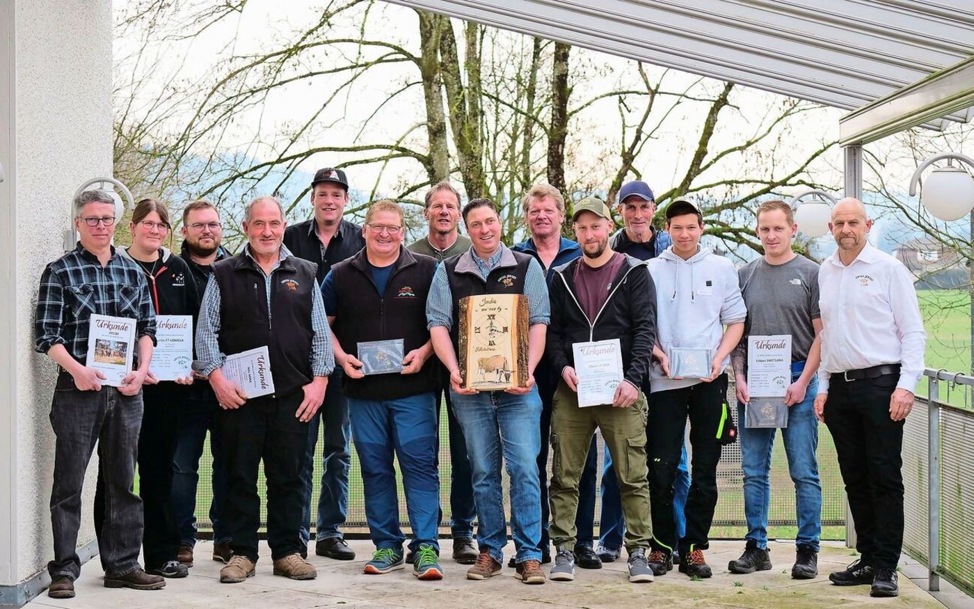 Die geehrten Züchterinnen und Züchter mit ihren Auszeichnungen. Mittendrin steht Christoph Rohrbach mit seiner Auszeichnung (Holzuhr) für seine 100 000er-Kuh Iatola India und ganz rechts Präsident André Stalder.