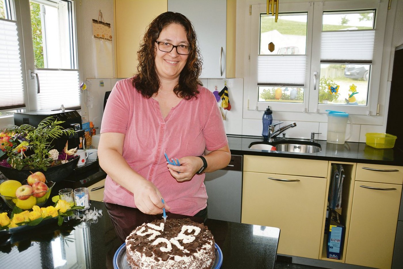 Doris Lustenberger steckt die Kerzen auf den Geburtstagskuchen von Sohn Eric, dieser hatte am Tag des Besuches Geburtstag. Schon 15 ist er geworden.(Bild Franziska Jurt)